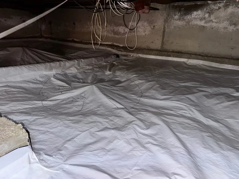 White radon membrane covering a crawl space floor with a suction pipe
