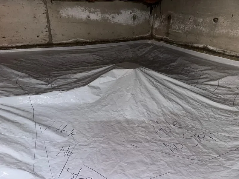 Radon membrane sealed up the foundation walls of a crawl space