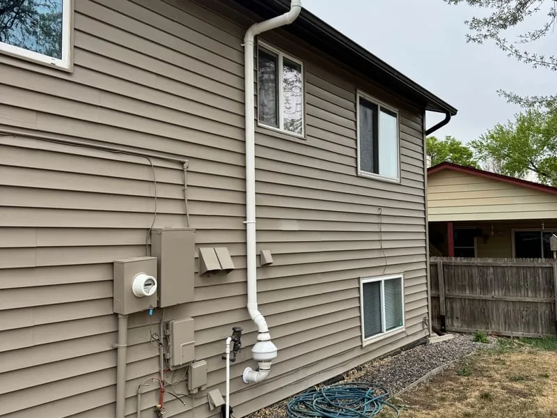 Radon pipe and fan routed up the outside of a Westminster home by the garage